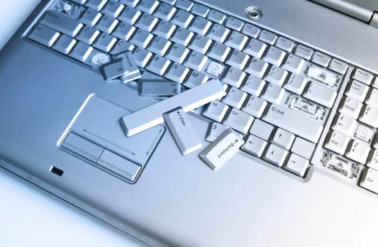 Computer keyboard with visible keys, highlighting its role in typing and keyboard repair needs.